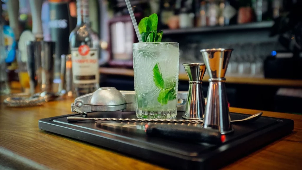 Mojito Drink in a Cocktail Tumbler Glass on a bar mat.